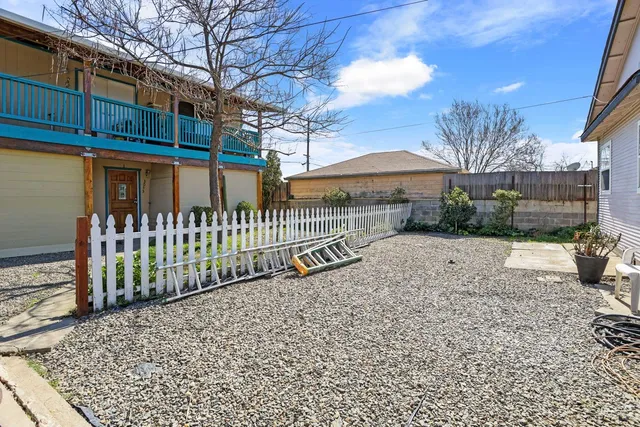 a view of a house with a yard and pathway