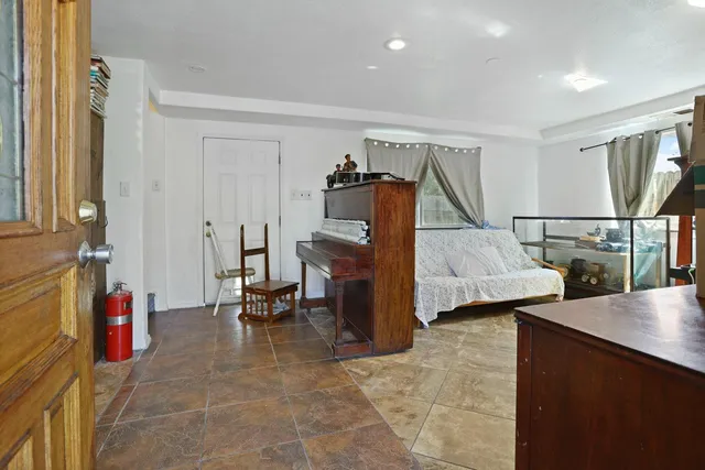 a bedroom with furniture and a window