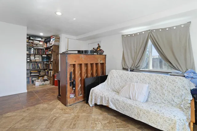 a living room with a couch and a book shelf