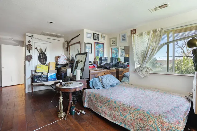 a bedroom with bed and glass door