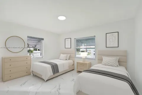 a bedroom with two beds and a dresser