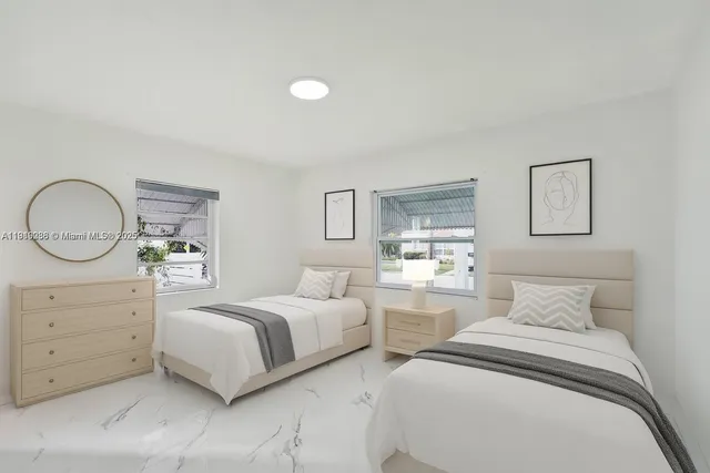 a bedroom with two beds and a dresser