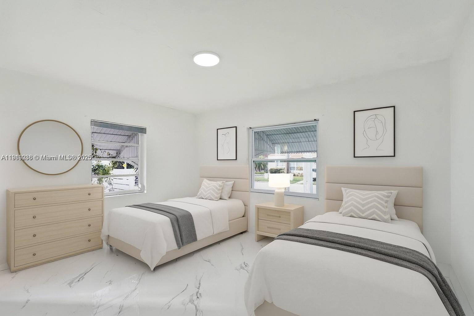 9173 Byron Avenue Surfside, FL 33154 - Photo 15 of 26 a bedroom with two beds and a dresser