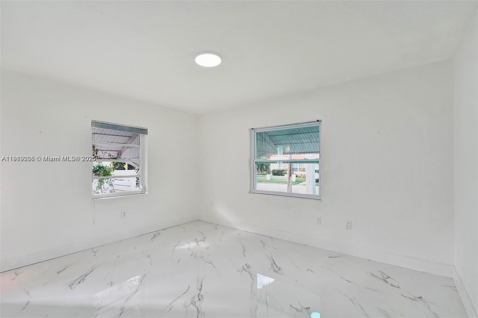 9173 Byron Avenue Surfside, FL 33154 - Photo 16 of 26 an empty room with windows