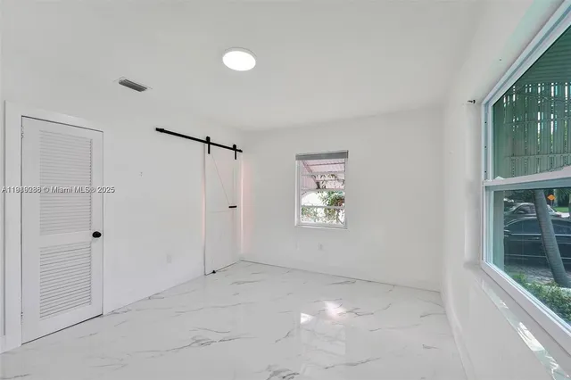 a view of an empty room with a window