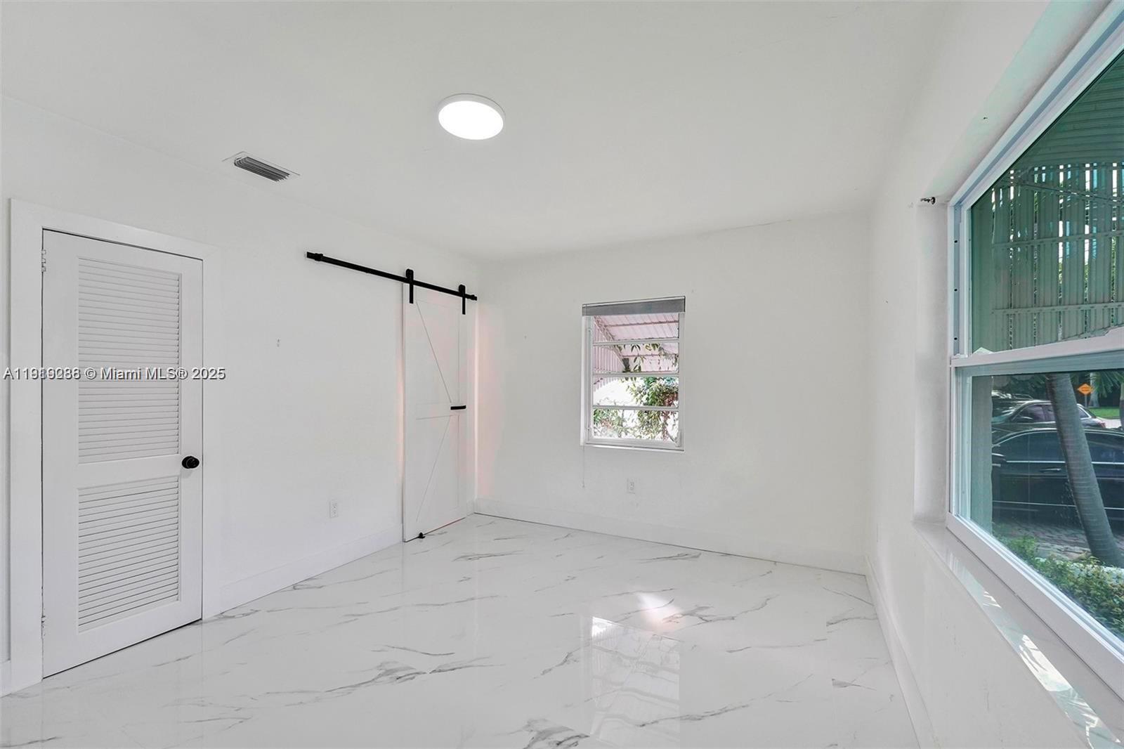 9173 Byron Avenue Surfside, FL 33154 - Photo 17 of 26 a view of an empty room with a window