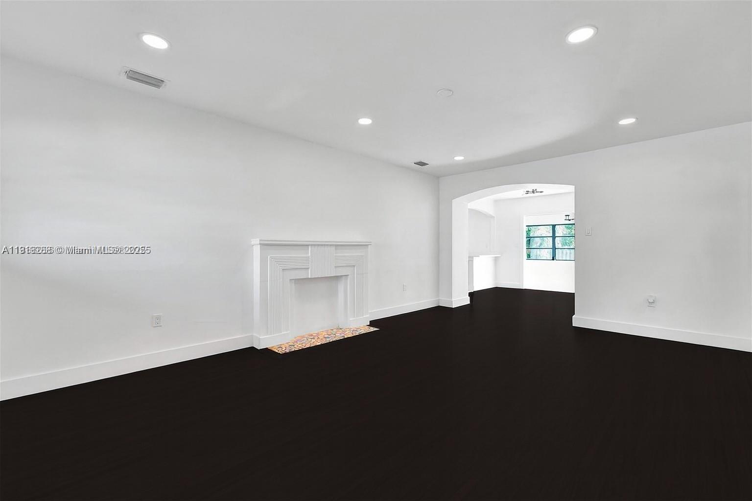 9173 Byron Avenue Surfside, FL 33154 - Photo 2 of 26 a view of an empty room with wooden floor and a window