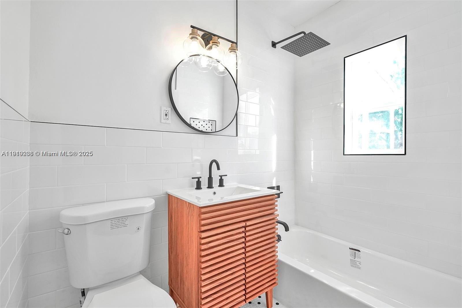 9173 Byron Avenue Surfside, FL 33154 - Photo 23 of 26 a bathroom with a sink a toilet and a mirror