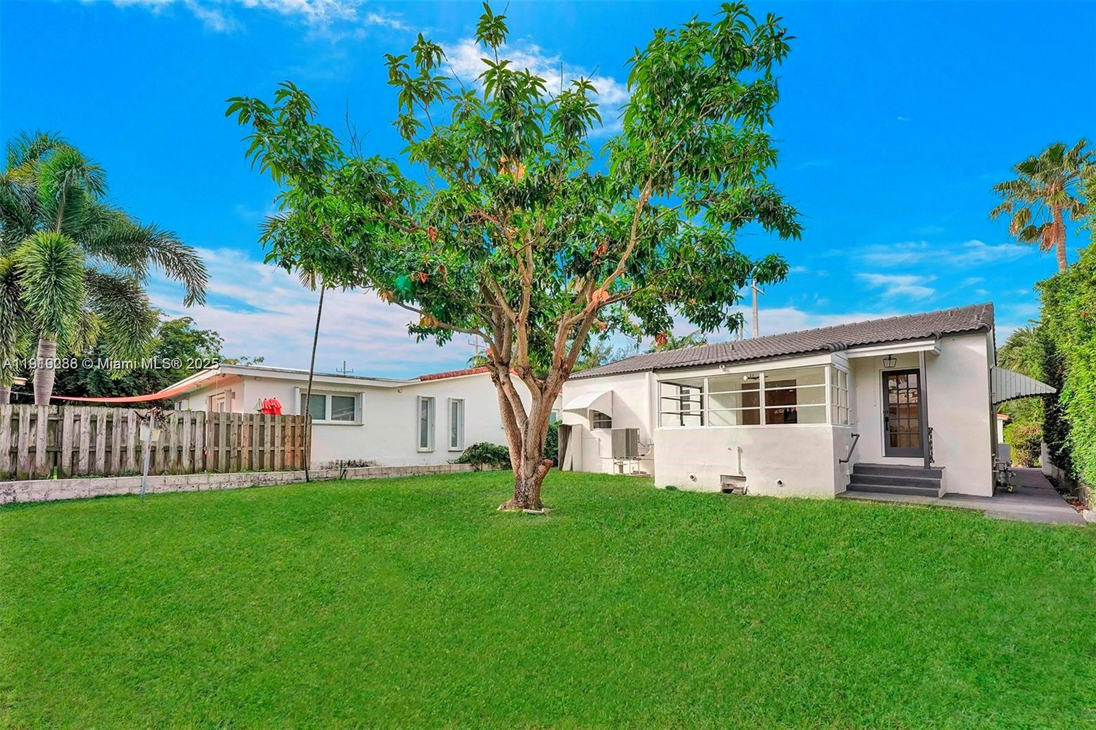 9173 Byron Avenue Surfside, FL 33154 - Photo 25 of 26 a front view of house with yard and green space