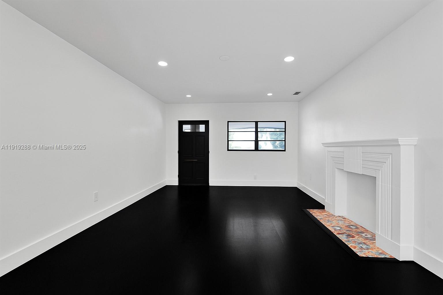 9173 Byron Avenue Surfside, FL 33154 - Photo 5 of 26 a view of an empty room with wooden floor and a window