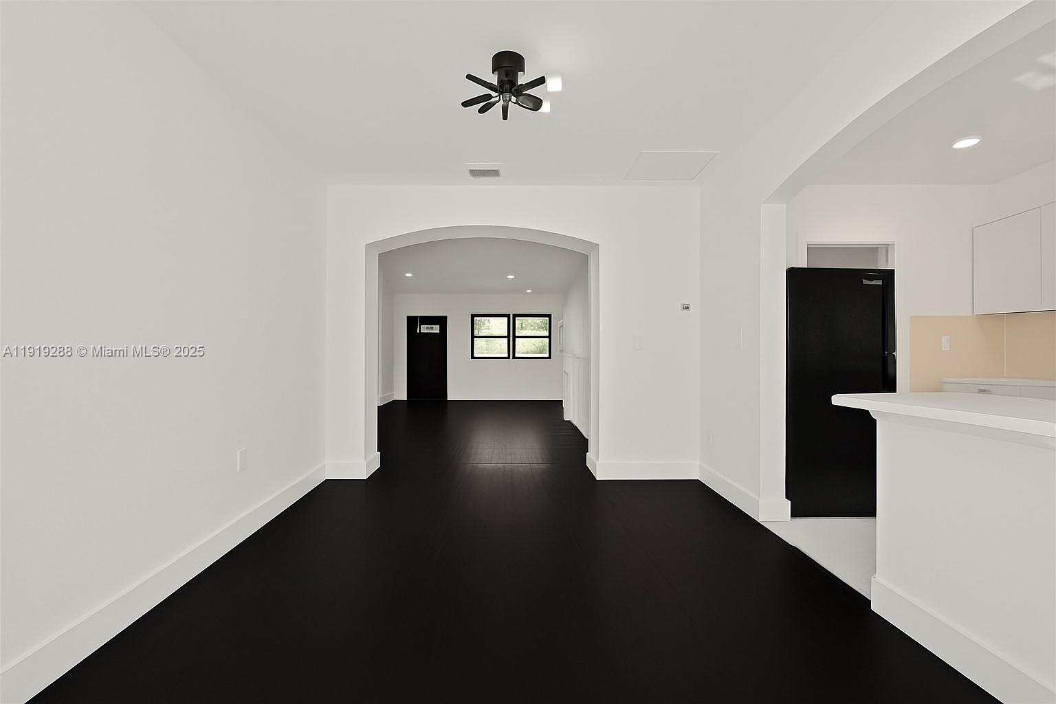 9173 Byron Avenue Surfside, FL 33154 - Photo 10 of 26 wooden floor in an empty room with a window