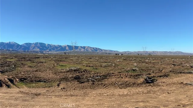 a view of a large mountain with a mountain in the background
