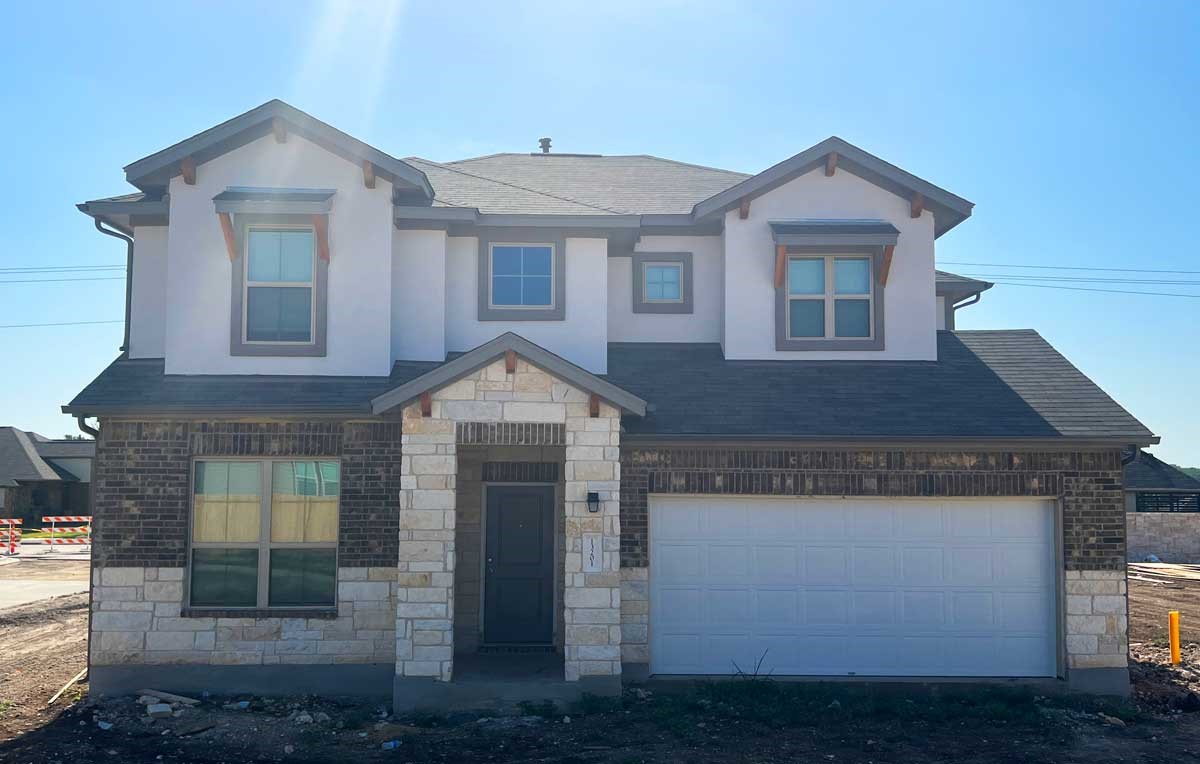 a front view of a house with a yard