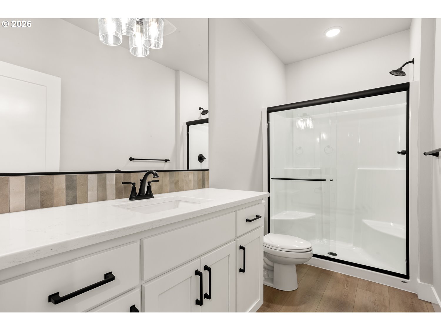 7321 Southwest Windflower Street Wilsonville, OR 97070 - Photo 14 of 20 a bathroom with a sink a toilet a mirror and shower