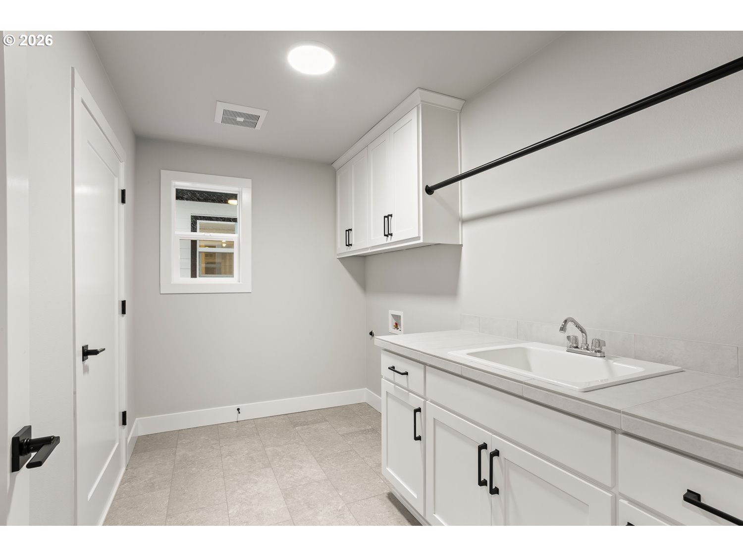 7321 Southwest Windflower Street Wilsonville, OR 97070 - Photo 20 of 20 a kitchen with a sink cabinets and a window