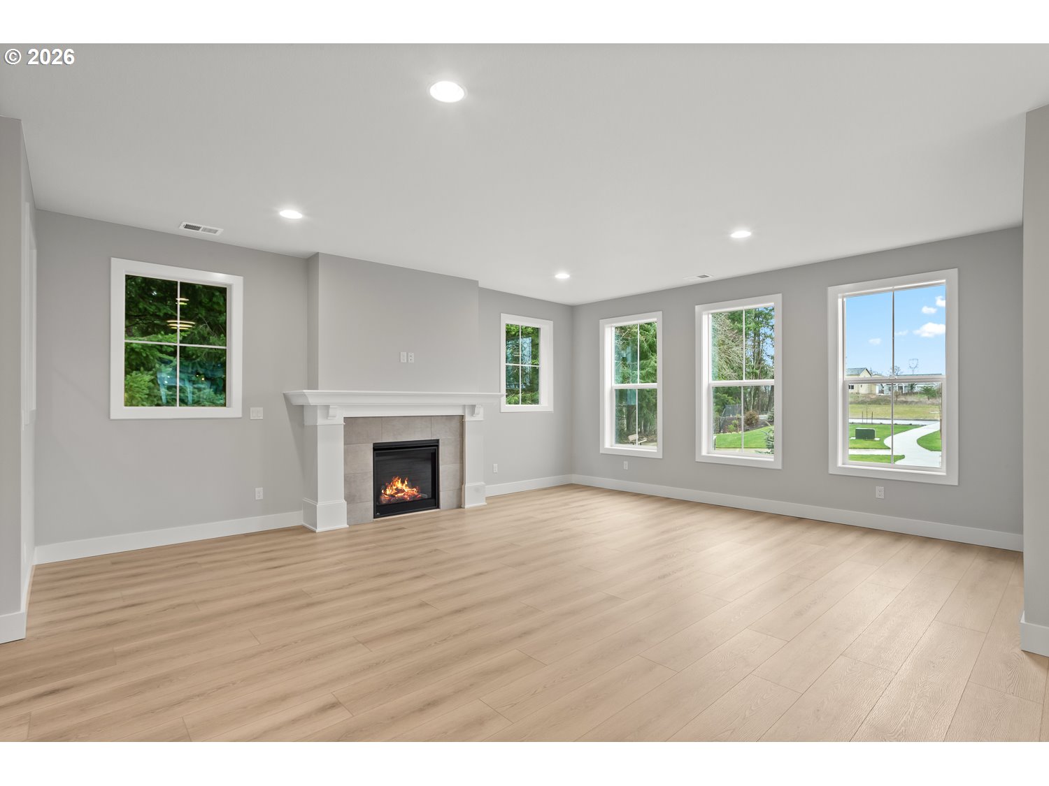 7321 Southwest Windflower Street Wilsonville, OR 97070 - Photo 10 of 20 a view of empty room with wooden floor and fireplace