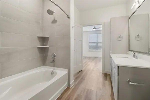 a bathroom with a tub sink and shower