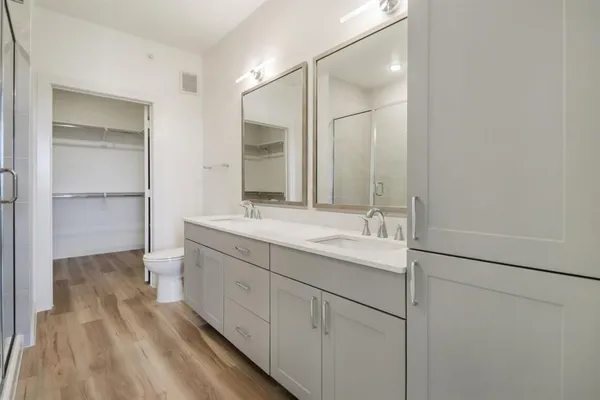 a bathroom with a double vanity sink and mirror