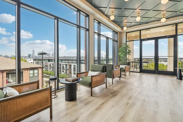 a living room with furniture and floor to ceiling windows