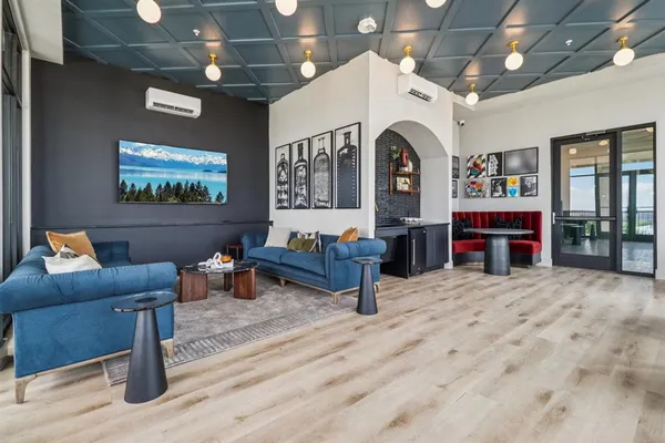 a living room with furniture a fireplace and a chandelier