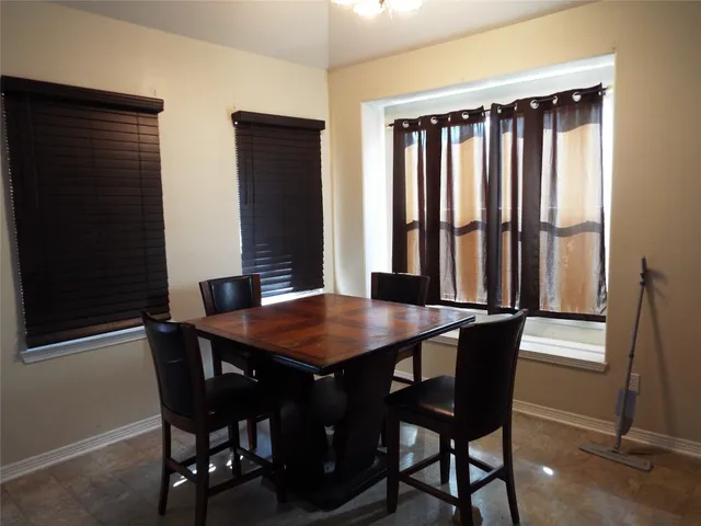 a dining room with furniture and window