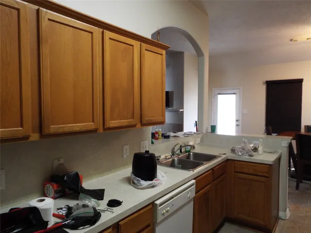 a kitchen with a sink cabinets and a window