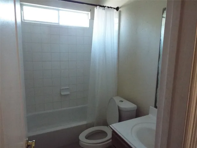 a bathroom with a toilet and shower