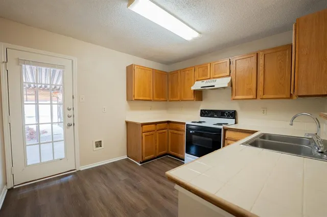 a kitchen with a refrigerator stove and sink