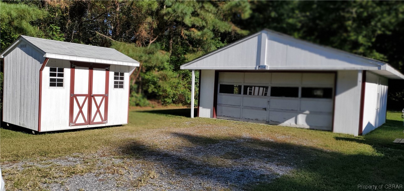368 Osprey Road Cardinal, VA 23025 - Photo 8 of 23 a view of a house with a yard and garage