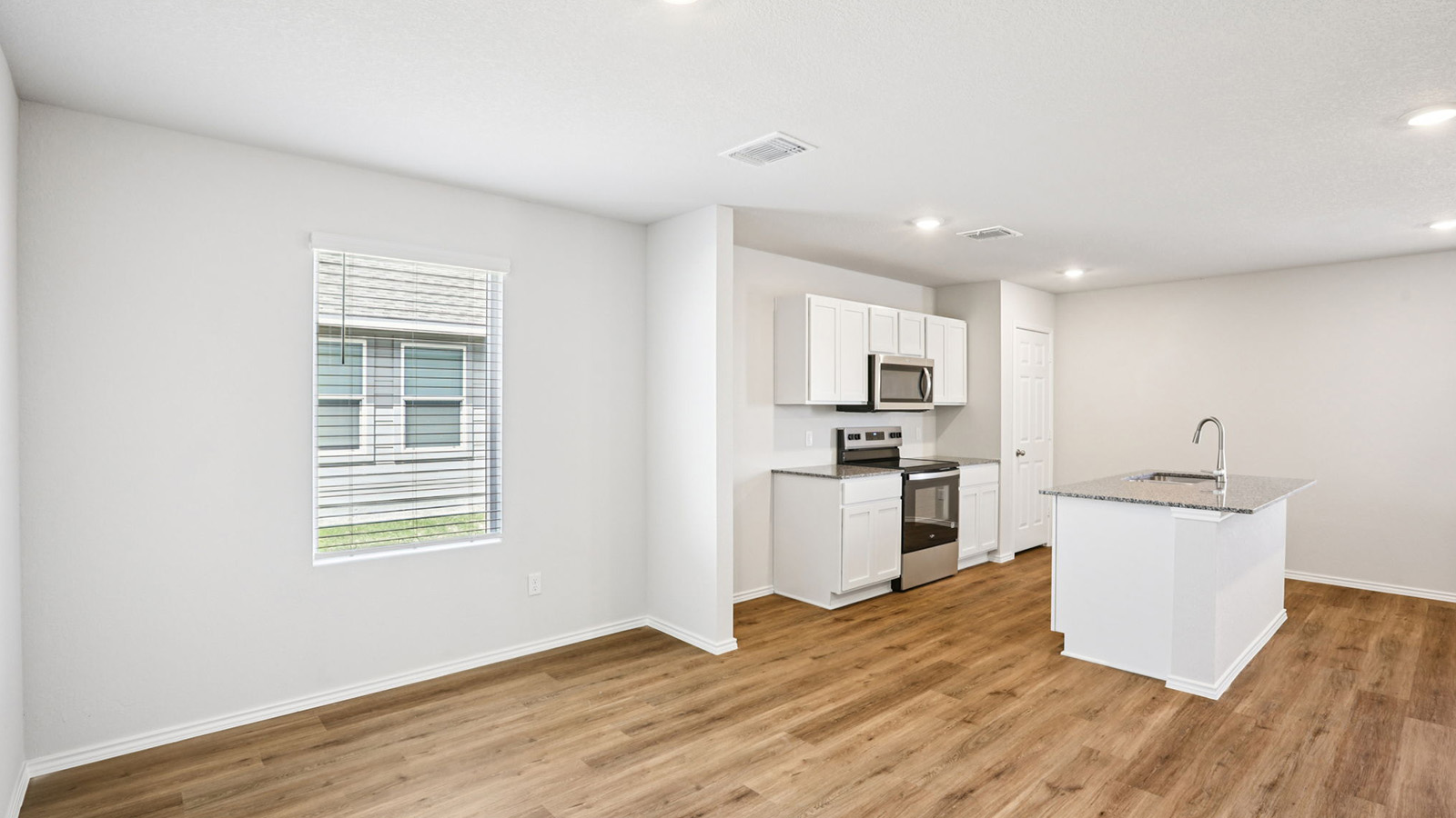 133 Wyatt Way Jarrell, TX 76537 - Photo 7 of 32 Open-concept living space featuring wood-finish flooring, recessed lighting, and a window with blinds