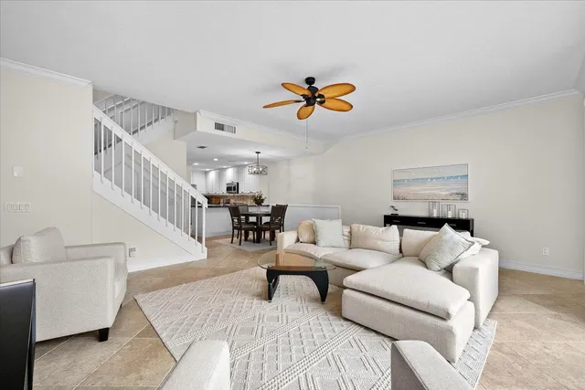 a living room with furniture and stairs