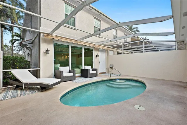 a view of a swimming pool with chairs