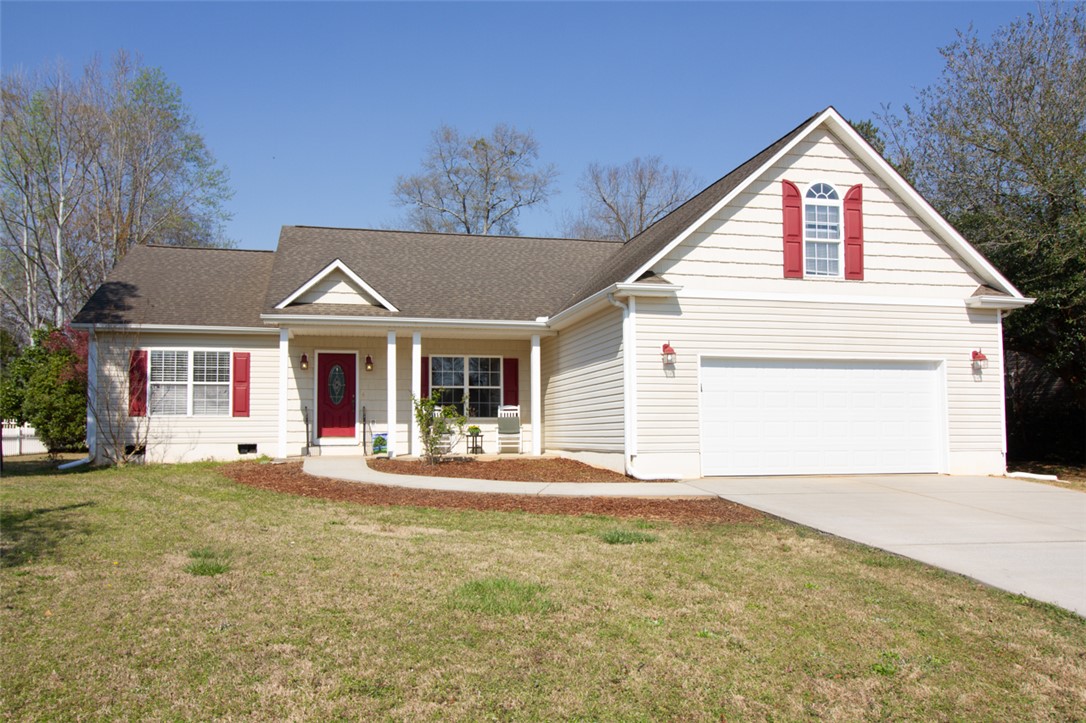This charming residence features a welcoming facade and convenient attached garage.