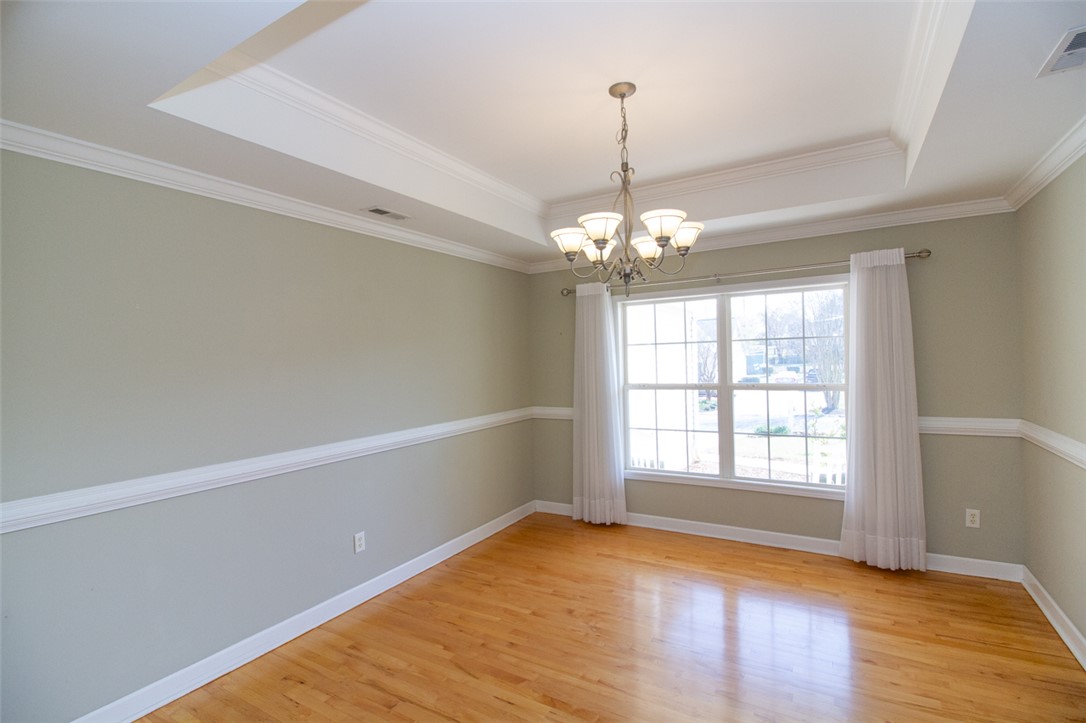 735 Britton Street Anderson, SC 29621 - Photo 11 of 49 This dining area features gleaming hardwood floors and elegant ceiling details, ready for memorable gatherings.