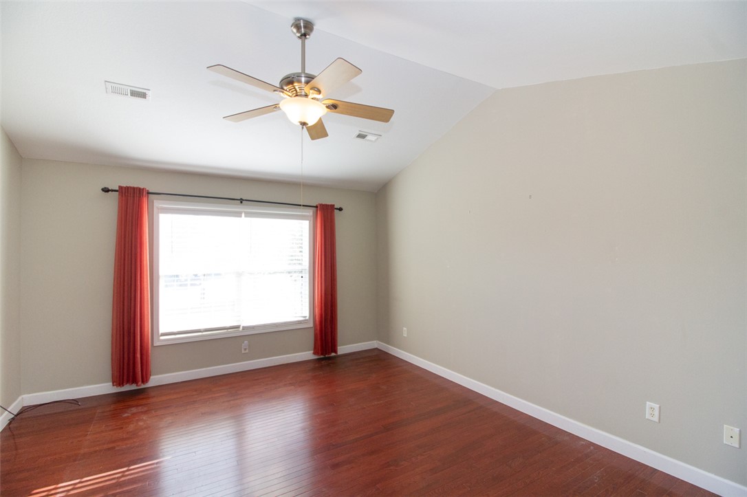 735 Britton Street Anderson, SC 29621 - Photo 26 of 49 This bright room features rich hardwood flooring and a sloped ceiling, offering a versatile living space.