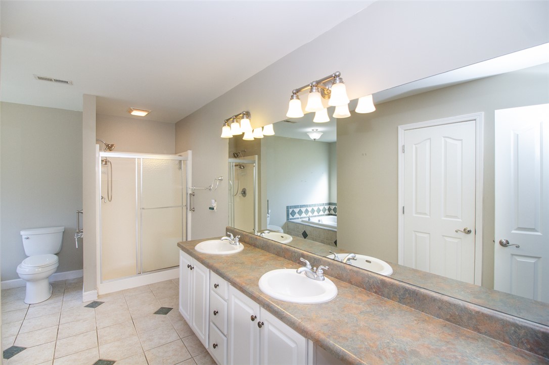 735 Britton Street Anderson, SC 29621 - Photo 27 of 49 This spacious bathroom offers dual vanities, a separate shower, and a large soaking tub.