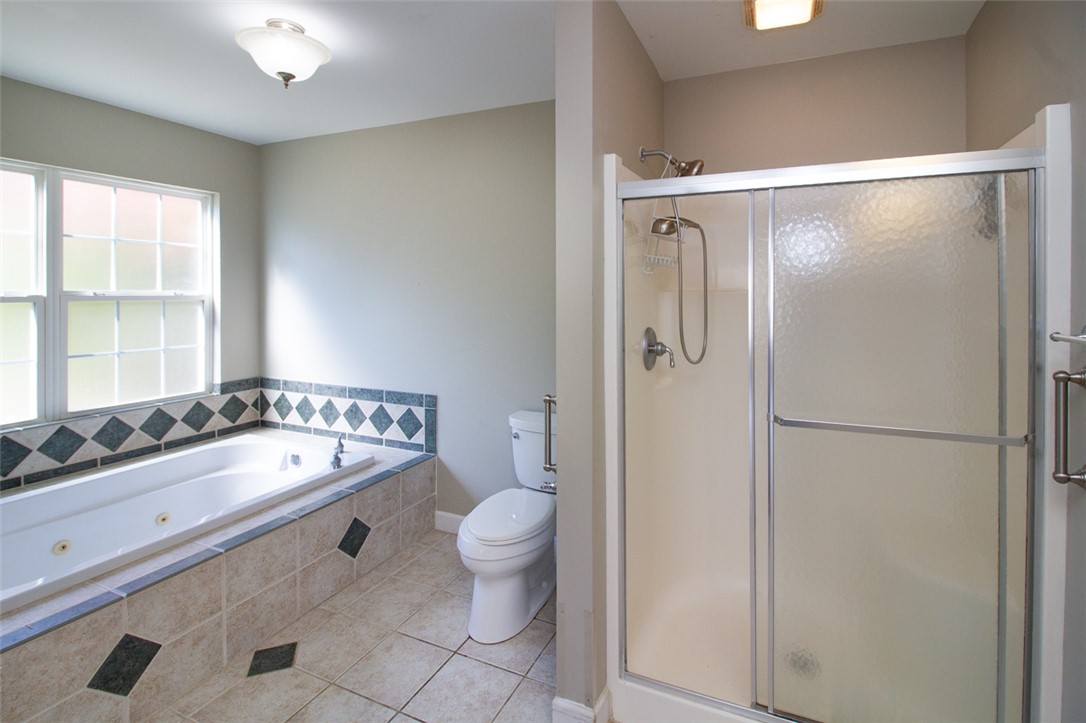 735 Britton Street Anderson, SC 29621 - Photo 29 of 49 This primary bathroom offers a combination of a shower stall and a soaking tub.