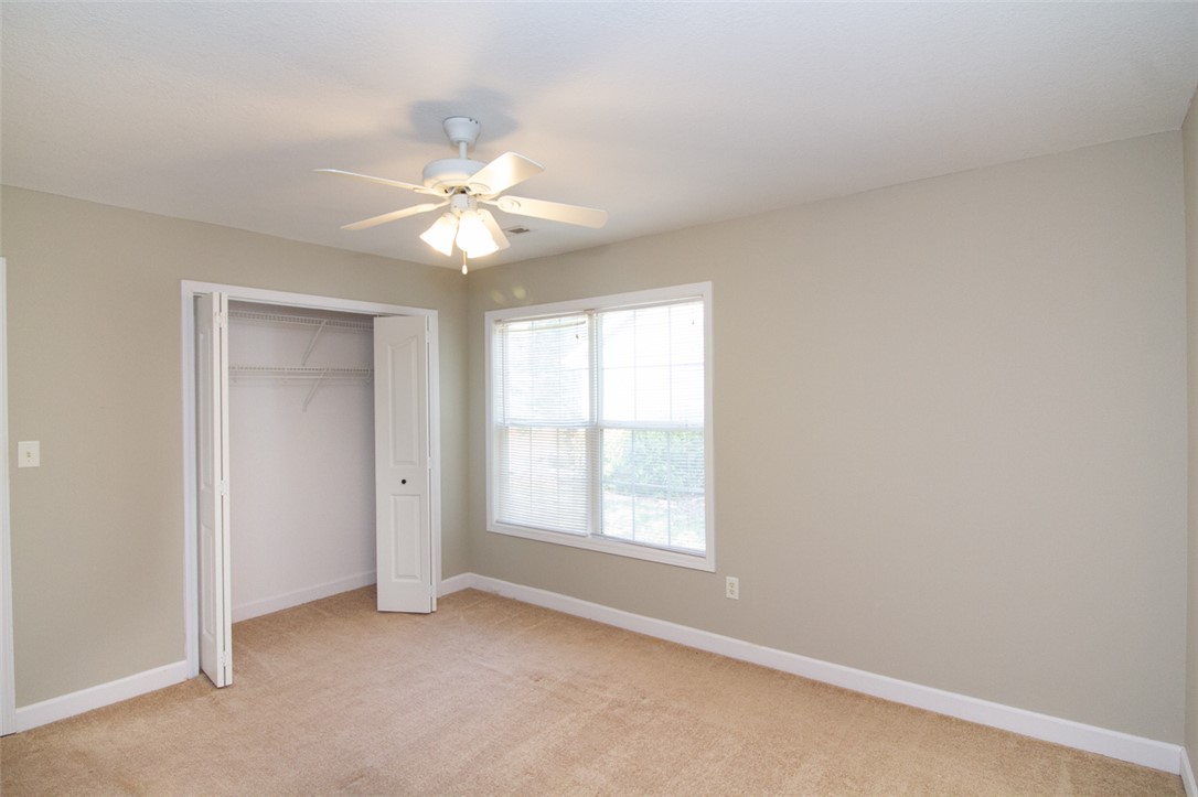 735 Britton Street Anderson, SC 29621 - Photo 34 of 49 This spacious bedroom offers ample natural light and comfortable carpeting, perfect for restful living.