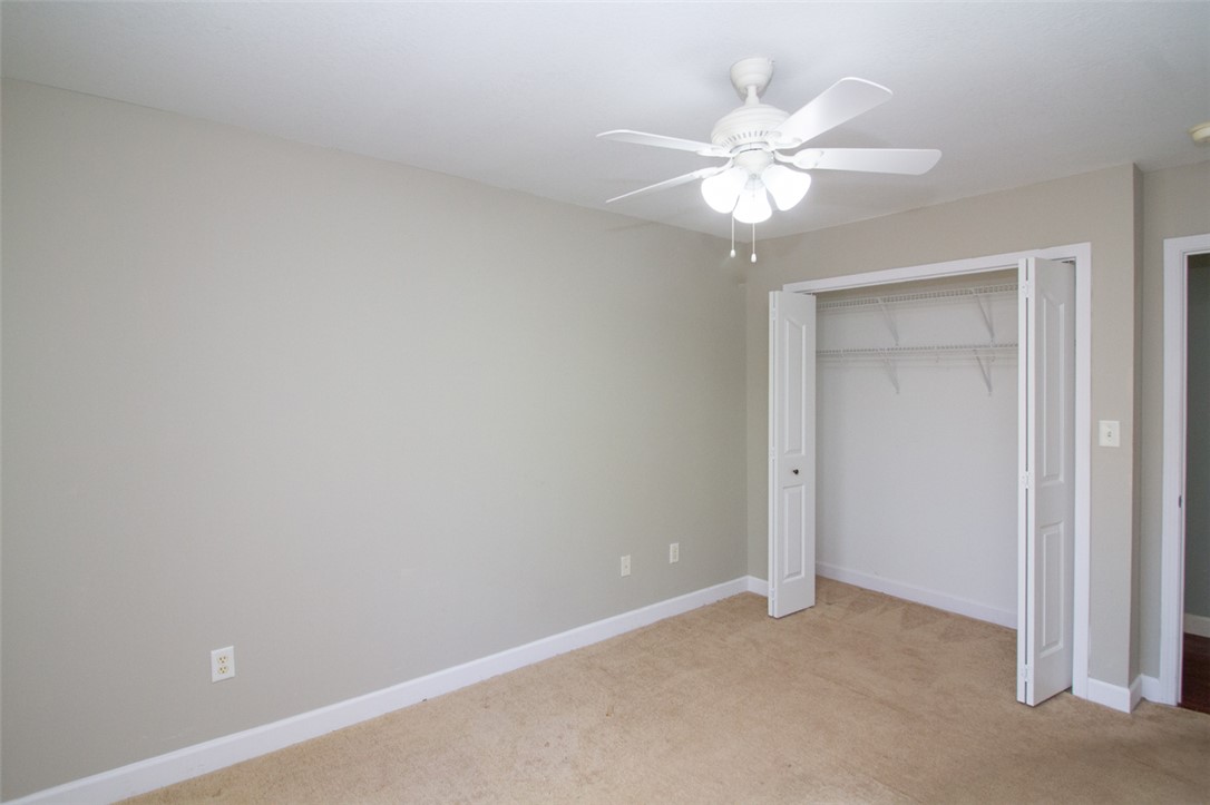 735 Britton Street Anderson, SC 29621 - Photo 36 of 49 This airy bedroom features a ceiling fan, closet, and neutral carpet, creating a serene and inviting space.