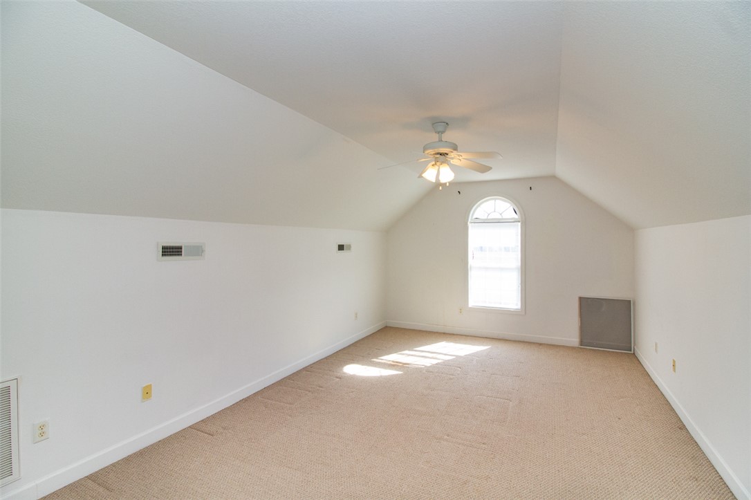 735 Britton Street Anderson, SC 29621 - Photo 39 of 49 Bright, spacious Bonus room with sloped ceilings and ample natural light through an arched window.