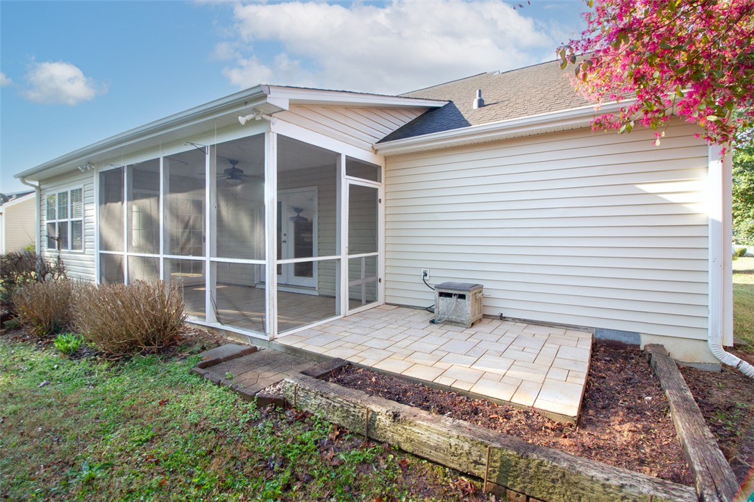 735 Britton Street Anderson, SC 29621 - Photo 49 of 49 This residence features a screened porch and a paved patio area, perfect for outdoor relaxation.