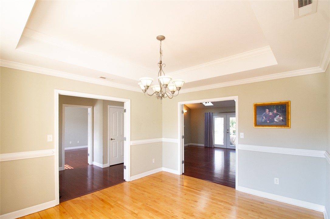 735 Britton Street Anderson, SC 29621 - Photo 9 of 49 This bright interior features crown molding and elegant wood flooring, creating an inviting atmosphere.