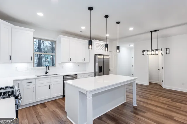a kitchen with stove cabinets and wooden floor