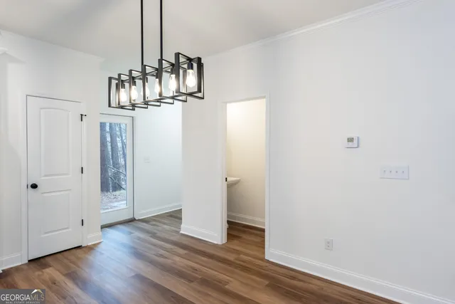 a kitchen with stainless steel appliances granite countertop a sink refrigerator and cabinets