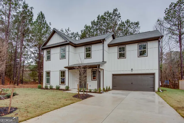 front view of house with a yard and trees