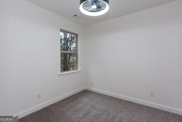 a view of a yard with trees in the background