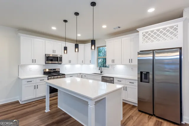 a kitchen with a wooden floor and white appliances