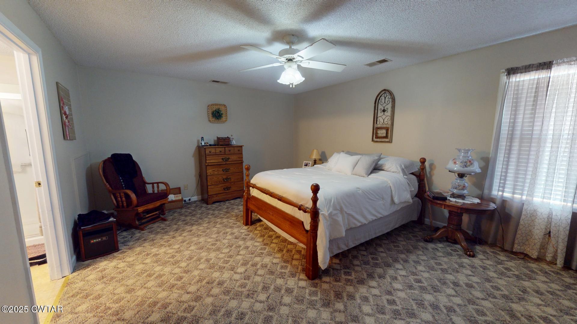 4836 Lightfoot Luckett Road Ripley, TN 38063 - Photo 16 of 23 a bedroom with a bed and a chandelier
