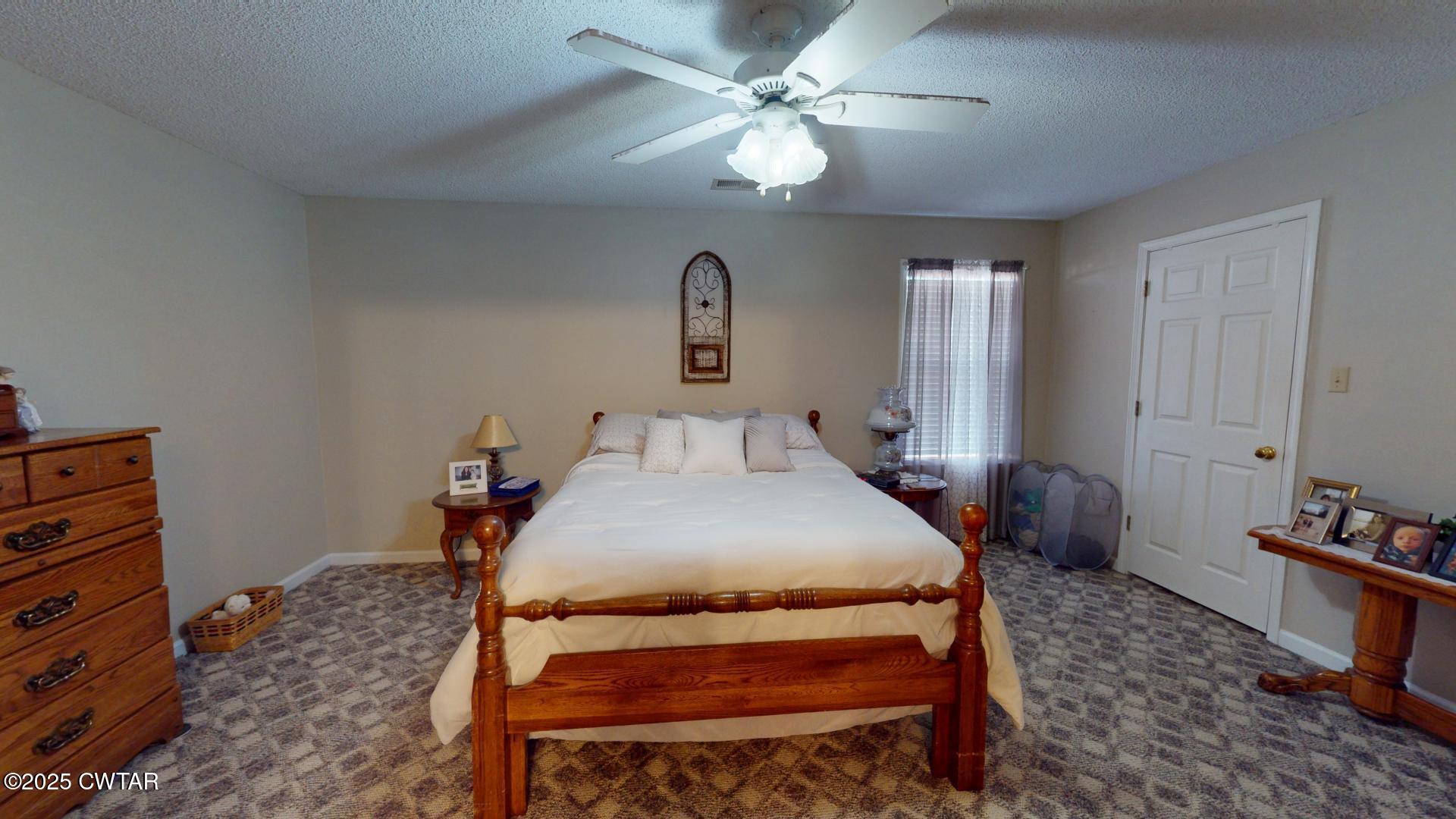 4836 Lightfoot Luckett Road Ripley, TN 38063 - Photo 17 of 23 a bedroom with a bed and a chandelier
