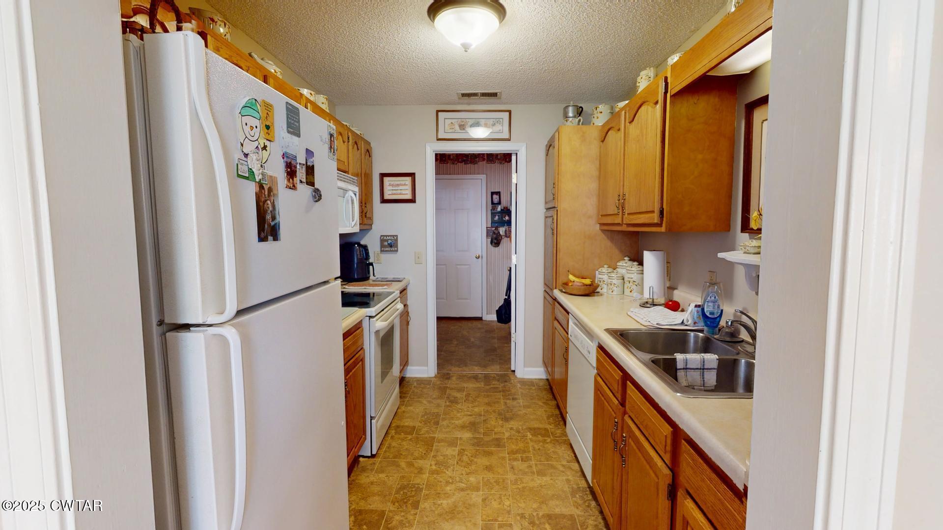 4836 Lightfoot Luckett Road Ripley, TN 38063 - Photo 19 of 23 a kitchen with a refrigerator a stove top oven a sink and dishwasher